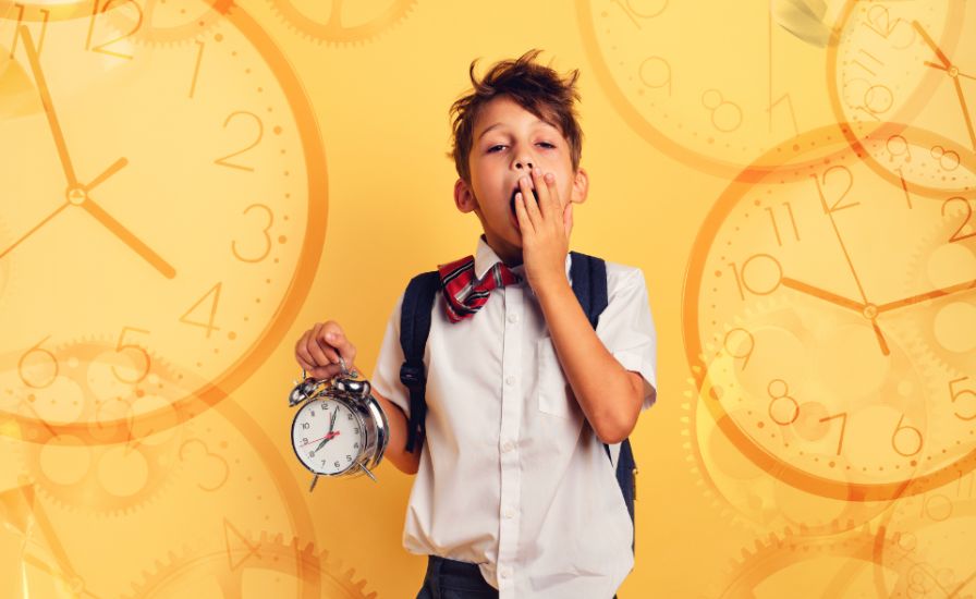 A young boy holding an alarm clock, looking at a clock